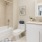 well lit bathroom with shower and tub