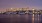 harbor with city skyline at night in the background